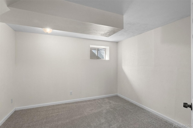 empty room featuring carpet flooring and baseboards