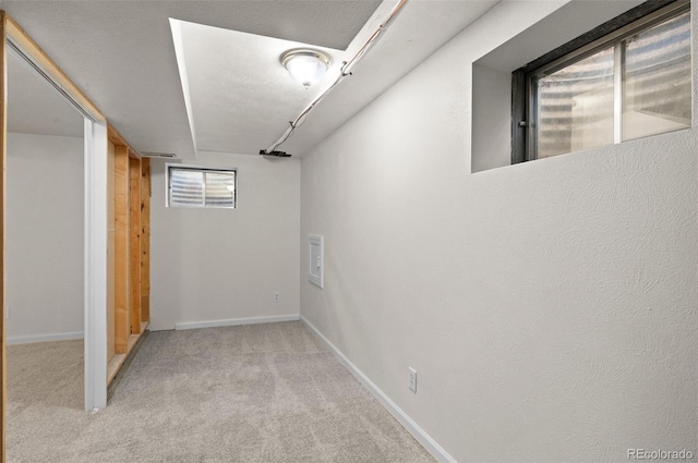 below grade area with baseboards and carpet