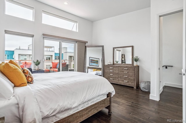 bedroom with dark hardwood / wood-style flooring and a high ceiling