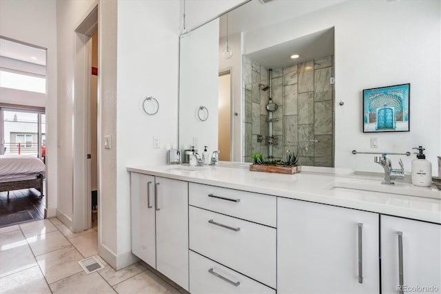 bathroom with dual bowl vanity, a shower with shower door, and tile flooring