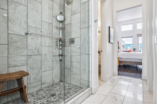 bathroom with walk in shower and tile flooring