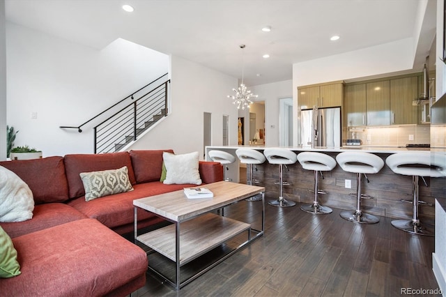 living room featuring dark hardwood / wood-style flooring and a notable chandelier