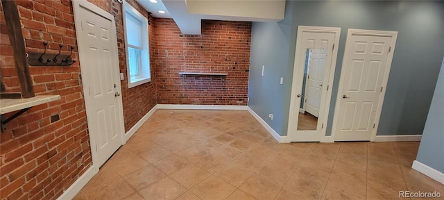 entryway featuring brick wall