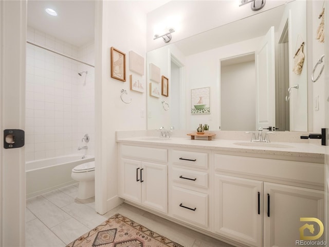 bathroom with shower / bath combination, double vanity, toilet, and a sink