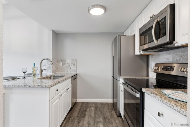 3100 S Federal Blvd Unit 331, Denver, CO 80236 - kitchen featuring stainless steel appliances, a sink, dark wood-style floors, backsplash, and light stone counters