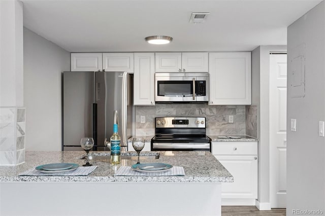 3100 S Federal Blvd Unit 331, Denver, CO 80236 - kitchen with appliances with stainless steel finishes, tasteful backsplash, and white cabinets