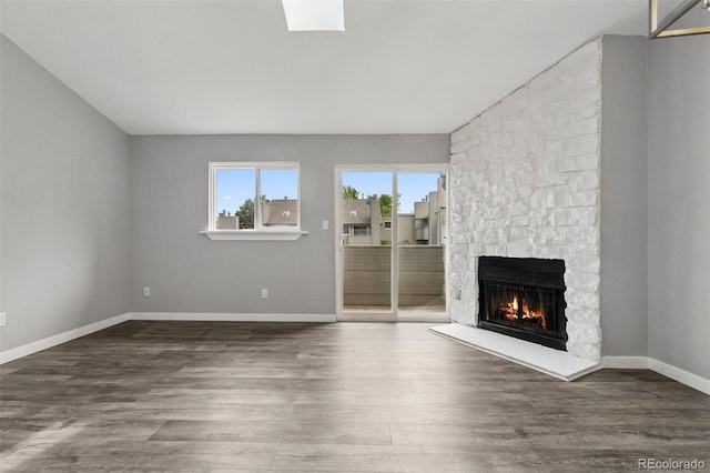 3100 S Federal Blvd Unit 331, Denver, CO 80236 - unfurnished living room with a stone fireplace, wood finished floors, and baseboards