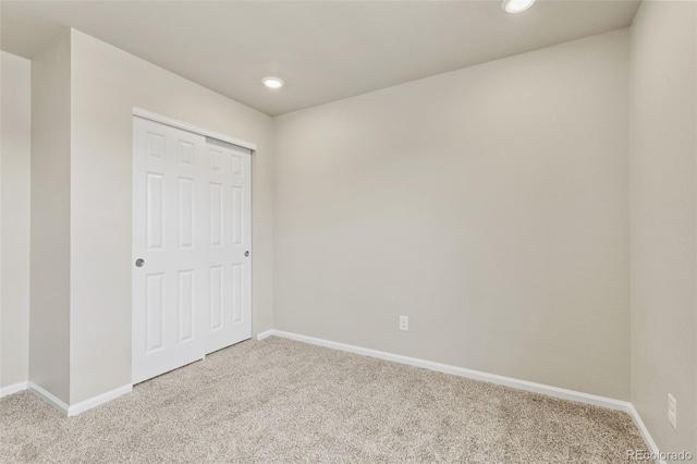 762 N Rome St, Aurora, CO 80018 - unfurnished bedroom featuring light colored carpet, baseboards, recessed lighting, and a closet