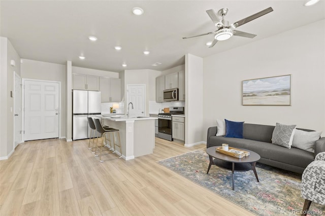 762 N Rome St, Aurora, CO 80018 - living room featuring ceiling fan, light wood-style flooring, recessed lighting, and baseboards