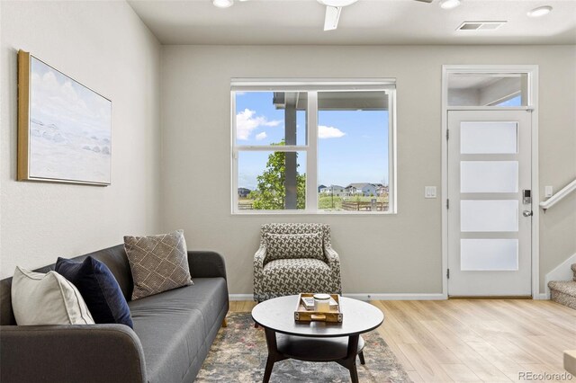 762 N Rome St, Aurora, CO 80018 - living area featuring light wood-style floors, stairs, baseboards, and recessed lighting