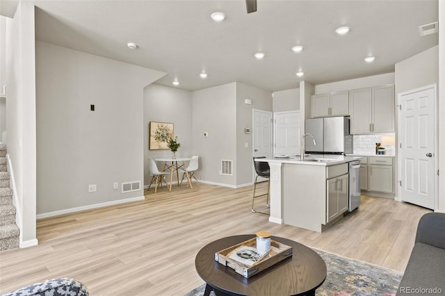 762 N Rome St, Aurora, CO 80018 - living area with light wood finished floors, baseboards, stairway, and recessed lighting