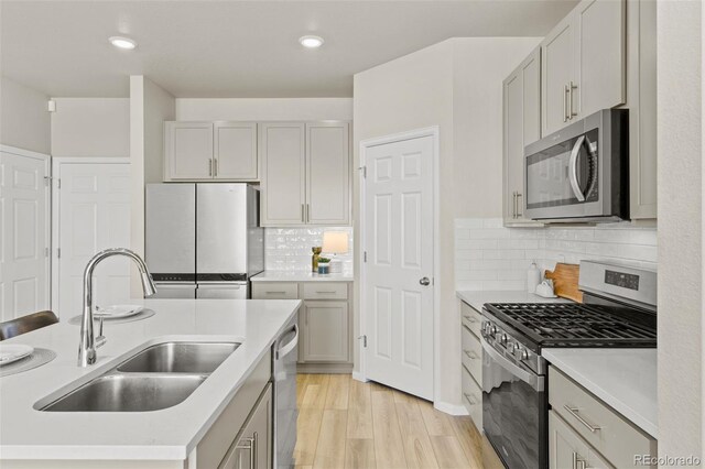 762 N Rome St, Aurora, CO 80018 - kitchen featuring appliances with stainless steel finishes, a sink, light wood-style flooring, light countertops, and recessed lighting