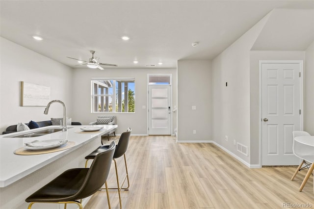 762 N Rome St, Aurora, CO 80018 - dining space with light wood finished floors, baseboards, a ceiling fan, and recessed lighting