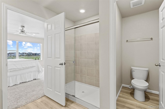 762 N Rome St, Aurora, CO 80018 - full bathroom featuring wood finished floors, a stall shower, ensuite bath, toilet, and baseboards