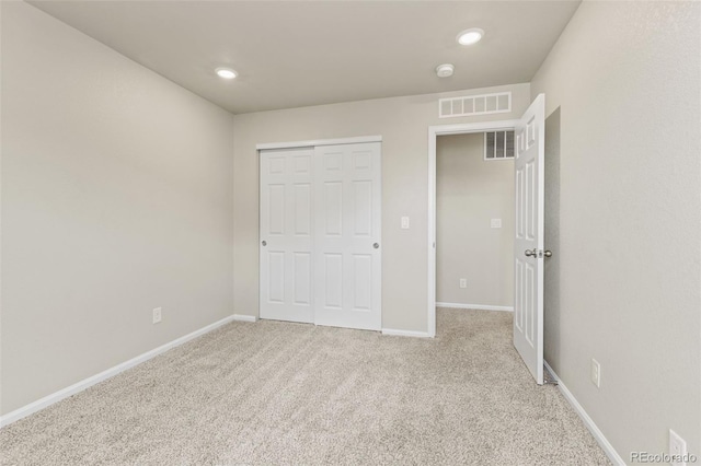 762 N Rome St, Aurora, CO 80018 - unfurnished bedroom with light colored carpet, a closet, baseboards, and recessed lighting