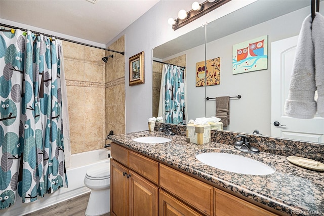 full bathroom featuring vanity, toilet, shower / bathtub combination with curtain, and hardwood / wood-style flooring