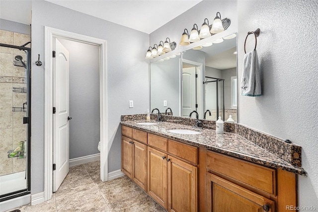 bathroom with vanity, toilet, and a shower with shower door