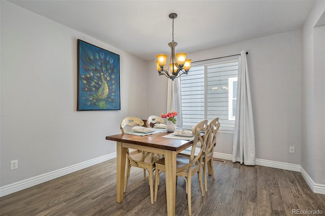 dining area with a wealth of natural light, a chandelier, and dark wood-type flooring