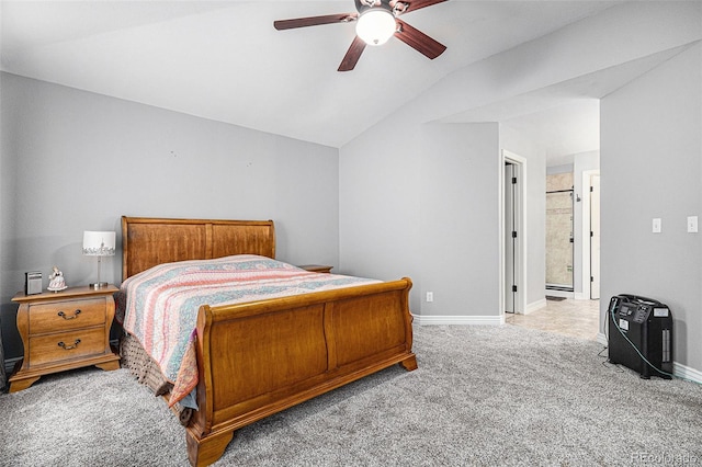 bedroom with light carpet, vaulted ceiling, ensuite bath, and ceiling fan