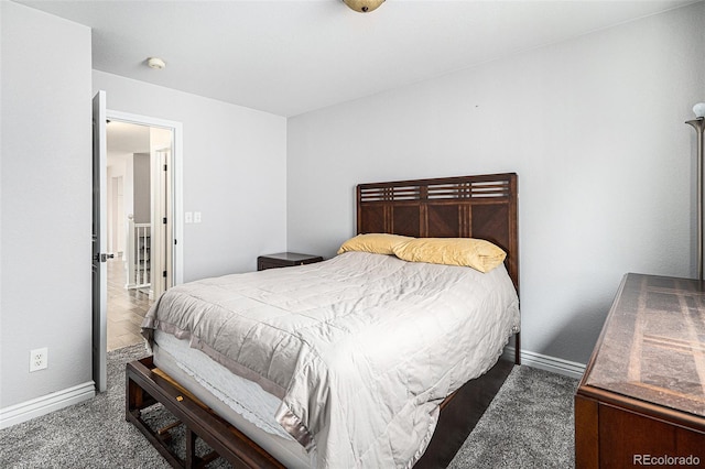 bedroom with dark colored carpet