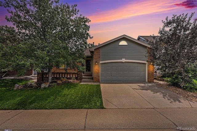 view of front facade with a yard and a garage