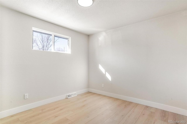 spare room featuring light hardwood / wood-style floors