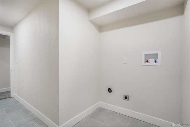 laundry area with hookup for a washing machine, hookup for an electric dryer, and light tile patterned floors