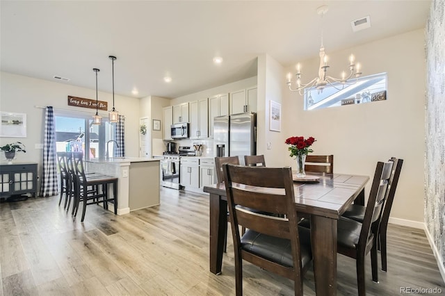 529 Beckwourth, Fort Lupton, CO 80621 - dining space with a chandelier, light wood-type flooring, and recessed lighting
