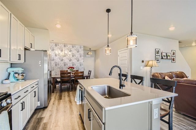 529 Beckwourth, Fort Lupton, CO 80621 - kitchen featuring backsplash, a kitchen breakfast bar, light countertops, light wood-style flooring, and recessed lighting