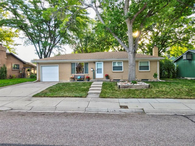 ranch-style home featuring a garage and a front yard