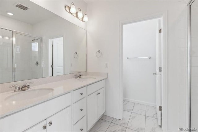 bathroom featuring vanity and an enclosed shower