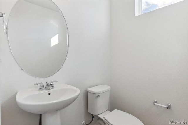 bathroom featuring toilet and sink