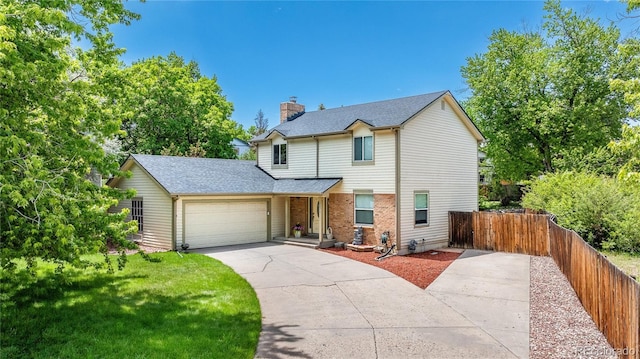 4571 S Memphis St, Aurora, CO 80015 - traditional-style home featuring an attached garage, driveway, a chimney, and roof with shingles