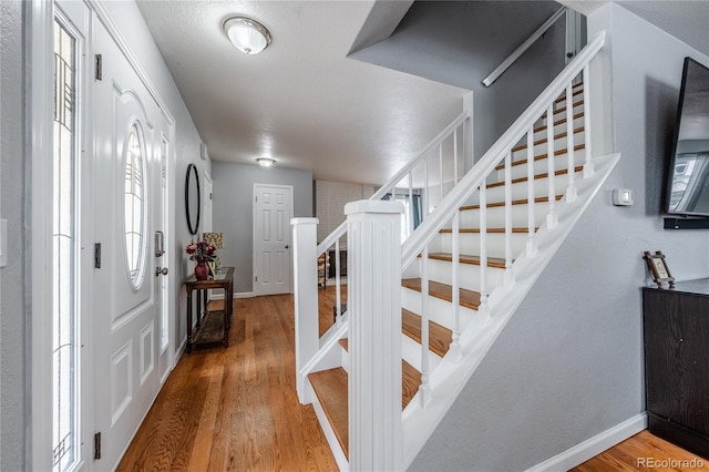 4571 S Memphis St, Aurora, CO 80015 - entrance foyer with stairway, wood finished floors, and baseboards