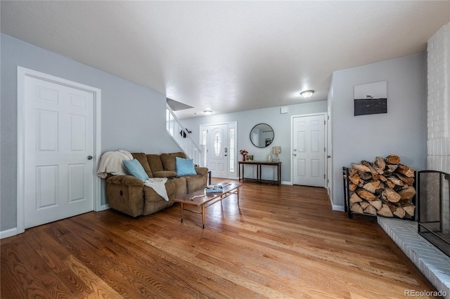 4571 S Memphis St, Aurora, CO 80015 - living room with stairway, light wood finished floors, and baseboards