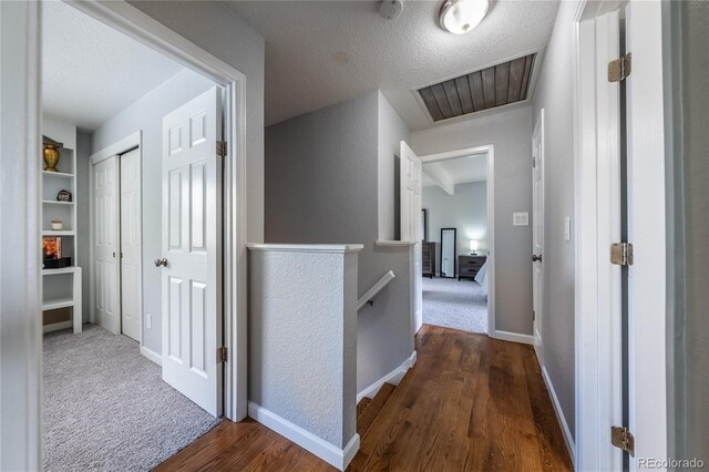 4571 S Memphis St, Aurora, CO 80015 - corridor with an upstairs landing, wood finished floors, baseboards, and a textured ceiling