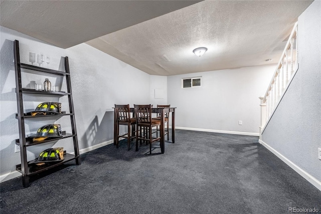 4571 S Memphis St, Aurora, CO 80015 - dining space featuring a textured ceiling, baseboards, stairway, a textured wall, and dark colored carpet