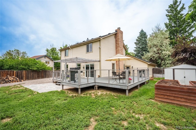 4571 S Memphis St, Aurora, CO 80015 - rear view of property with a chimney, a deck, and a patio area