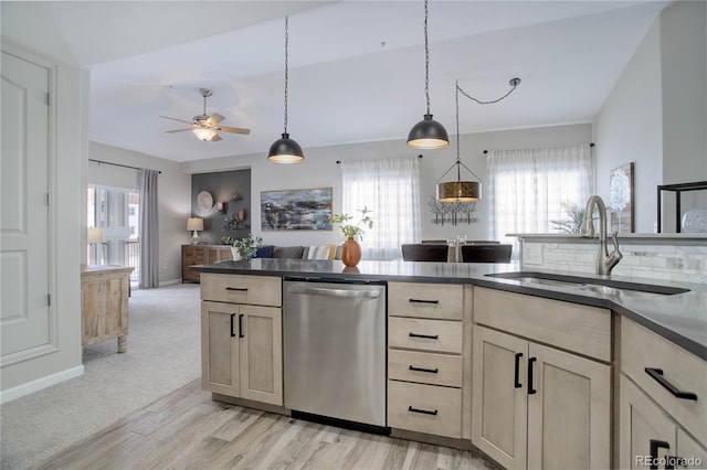 kitchen with sink, light wood-type flooring, dishwasher, pendant lighting, and ceiling fan