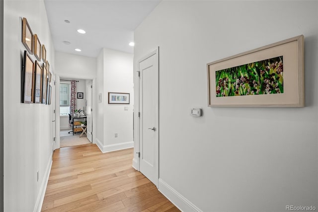 hallway with light hardwood / wood-style flooring