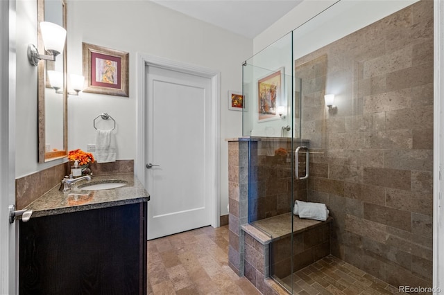 bathroom with a shower with door and vanity