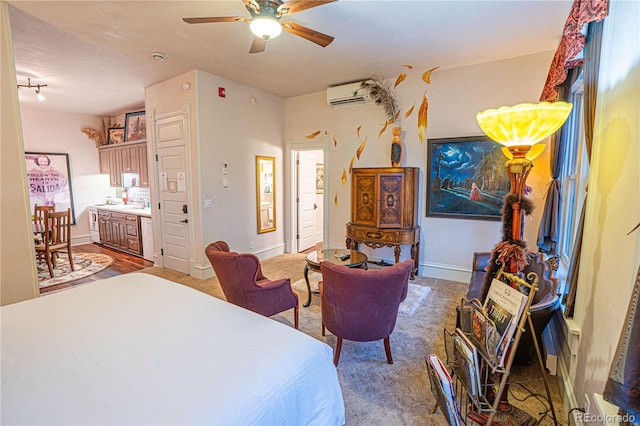 bedroom featuring a wall mounted air conditioner, sink, and ceiling fan