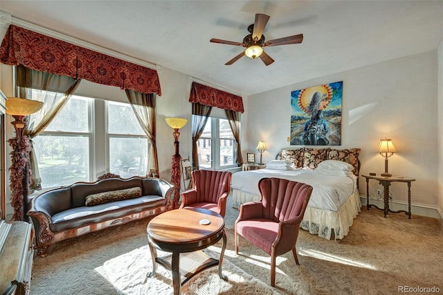 bedroom featuring carpet flooring, ceiling fan, and multiple windows