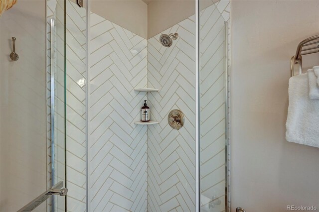 bathroom with a shower with door