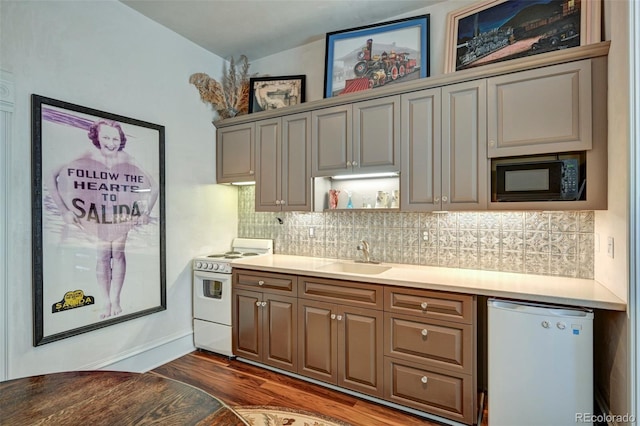 kitchen with white appliances, backsplash, dark wood-type flooring, sink, and lofted ceiling