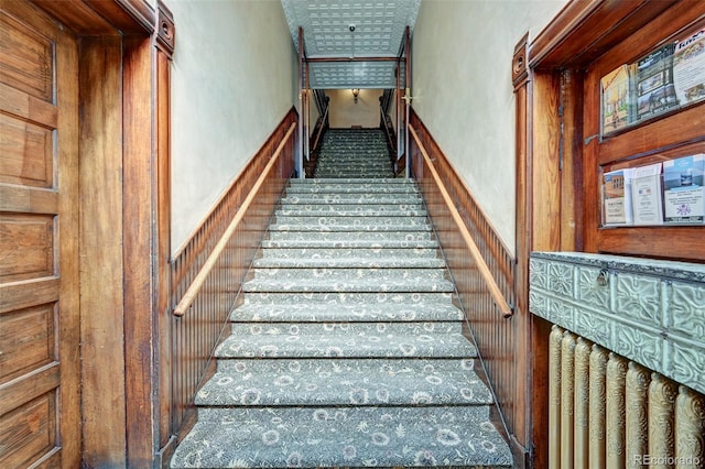 staircase with wood walls