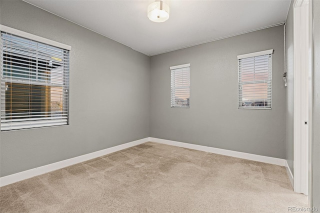 carpeted empty room featuring plenty of natural light