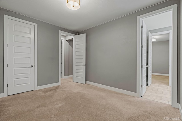 unfurnished bedroom with light carpet