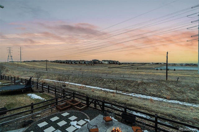 yard at dusk with a rural view