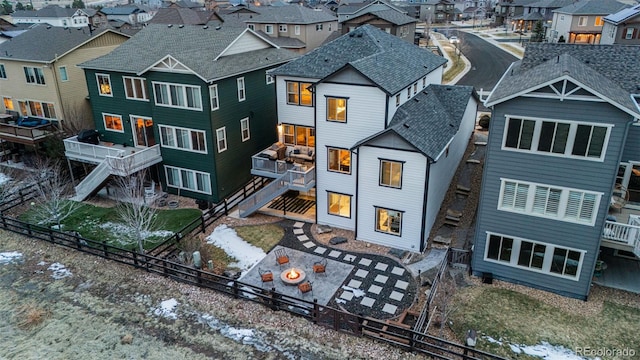 back of property featuring a fenced backyard, a residential view, stairs, a wooden deck, and a patio area